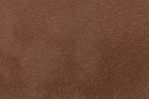 Matte brown fabric imitating animal fur. Leather background. Texture