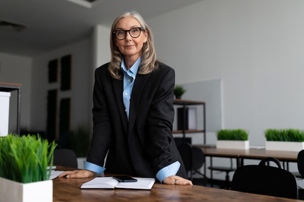 Mature adult female accountant with gray hair in office