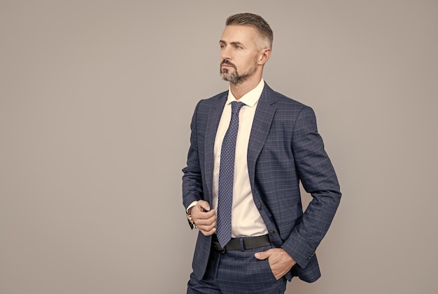 Mature ambitious man businessman in businesslike suit has grizzled hair business proffessionals