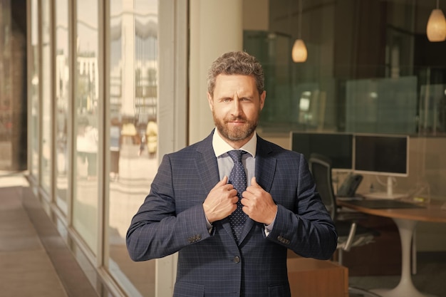 Mature bearded man businessperson in businesslike suit outside the office formalwear