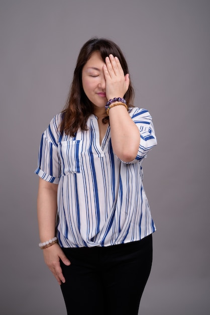 mature beautiful Asian businesswoman doing facepalm