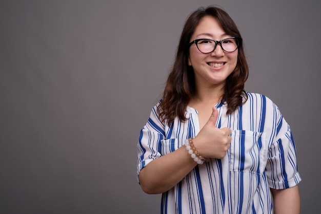 mature beautiful Asian businesswoman wearing eyeglasses