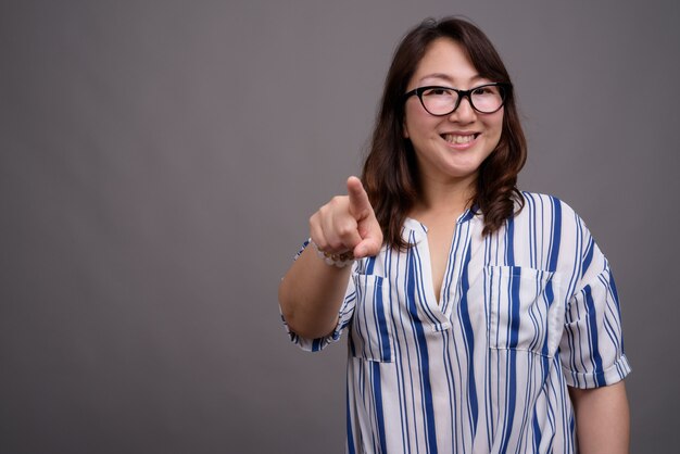 mature beautiful Asian businesswoman wearing eyeglasses