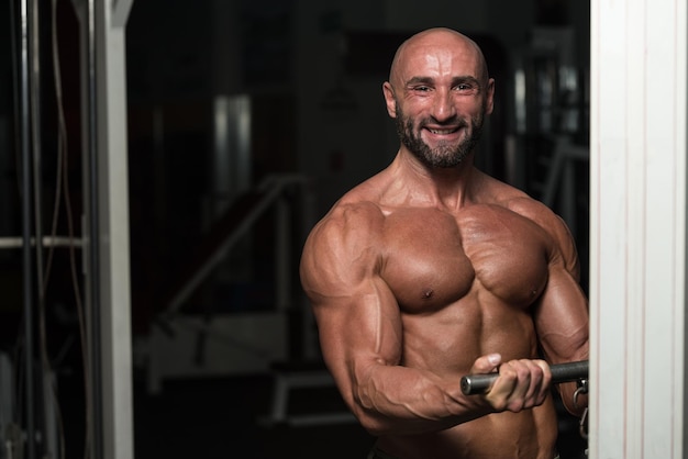 Mature Bodybuilder Exercise In The Gym  He Is Performing Two Arm Biceps Push Up