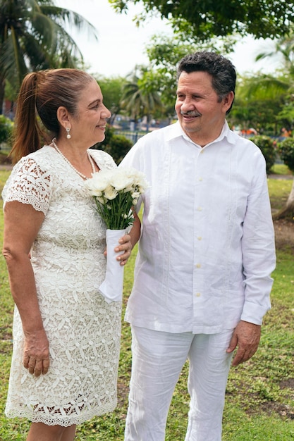 Mature bride and groom getting married in the garden