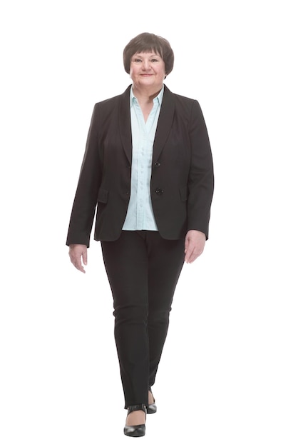 Mature business woman in a pantsuit striding forward