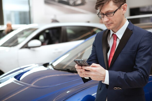 Mature businessman at car dealership