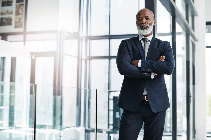 Photo mature businessman and confident with portrait in office of legal agency bureau and professional justice african entrepreneur serious with arms crossed in corporate company for litigation and law