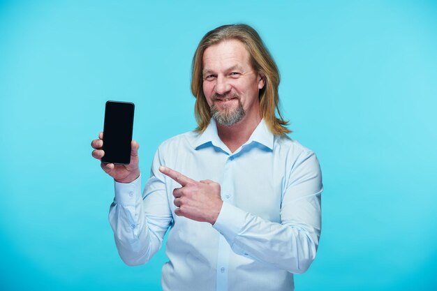 Mature businessman pointing at screen of smartphone