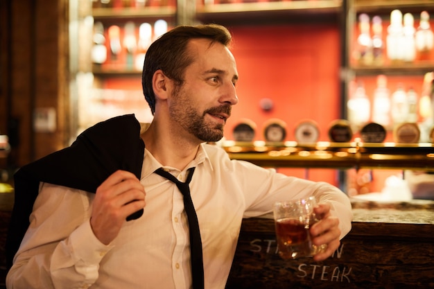 Mature Businessman Relaxing in Bar