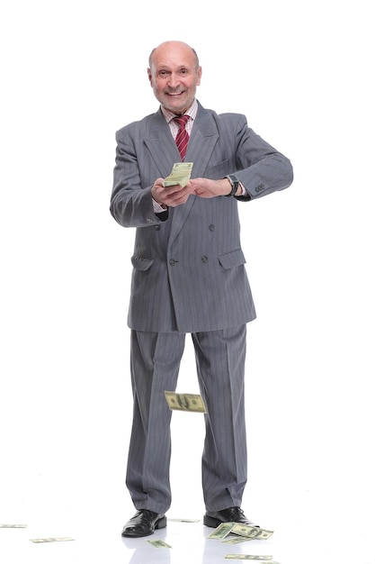 Mature businessman in suit and formal wear throwing in air dollar banknotes