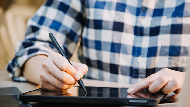 Mature businessman using a digital tablet to discuss information with a younger colleague