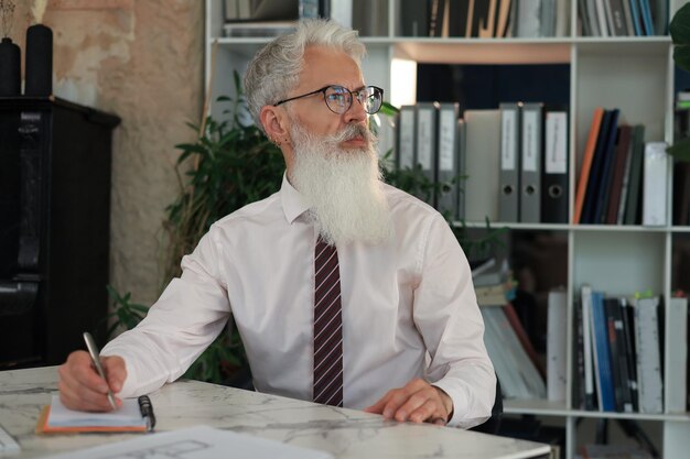 Mature businessman working on computer in modern office