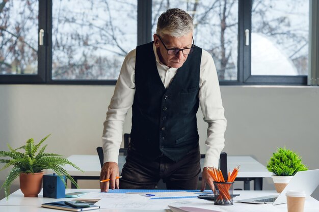 Mature businessman working at the desk in office