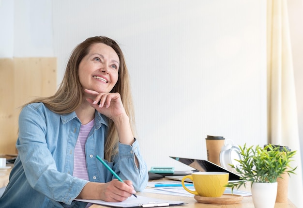 Mature businesswoman resting at workplace enjoy ending of workday