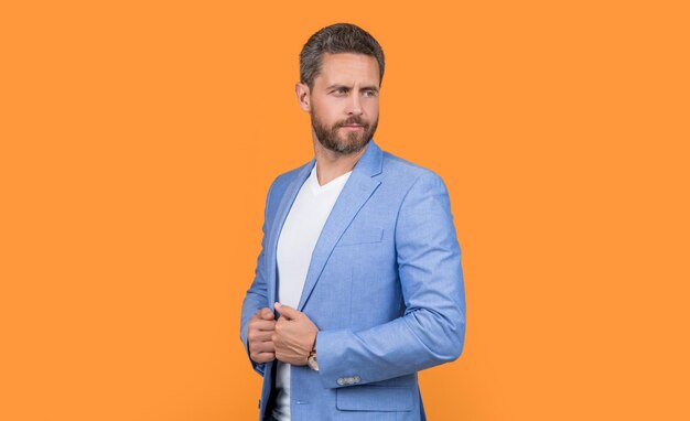 Mature caucasian boss in jacket isolated on yellow background boss in studio