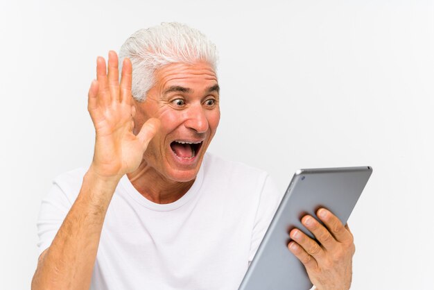 Mature caucasian man holding a tablet