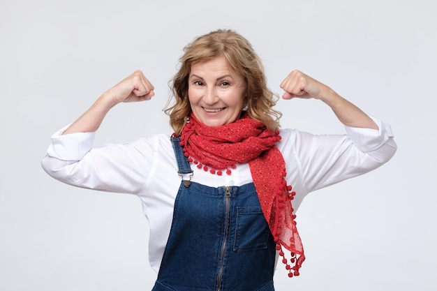 Mature caucasian woman showing biceps feeling strong