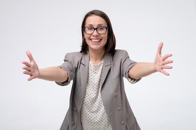 Mature caucasian woman smiling with open arms for hug