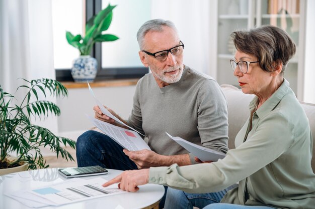 mature couple calculate expenses and planning monthly budget