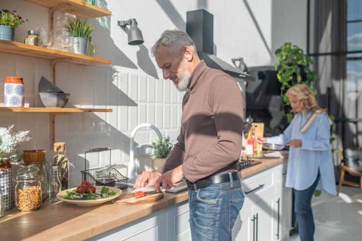 Mature couple cooking breakfast together