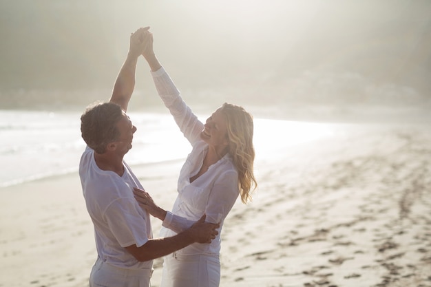 Mature couple having fun together at beach