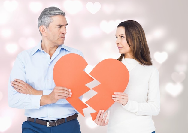 Mature couple holding a broken heart