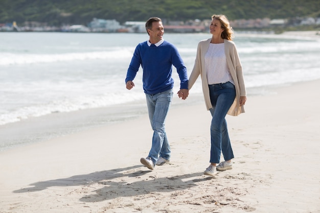 Mature couple holding hands while walking