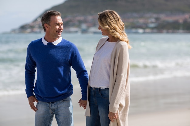 Mature couple holding hands while walking