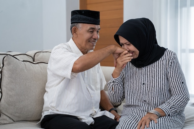 Mature couple kissing husband's hand