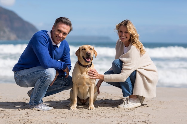 mature couple petting their dog