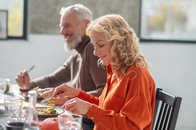 Mature couple sitting at the table and having dinner