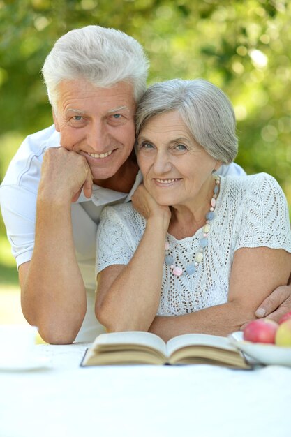 Mature couple at a table with a book