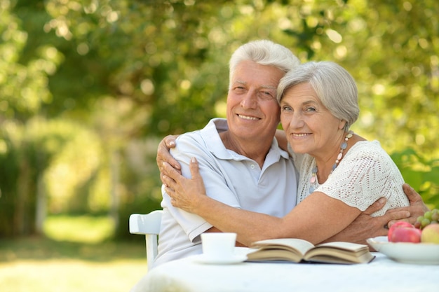 Mature couple at a table with a book