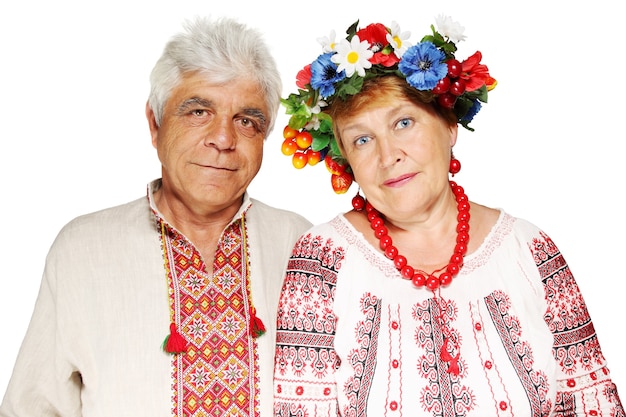 Mature couple in Ukrainian costumes on a white background