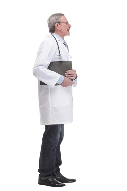 A mature doctor holding a clipboard and posing isolated against white background