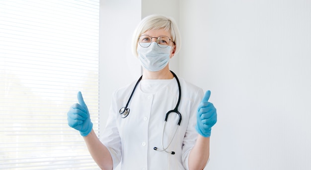 Mature doctor receives good results and shows thumbs up