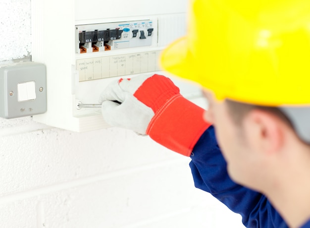 Mature electrician repairing a power plan