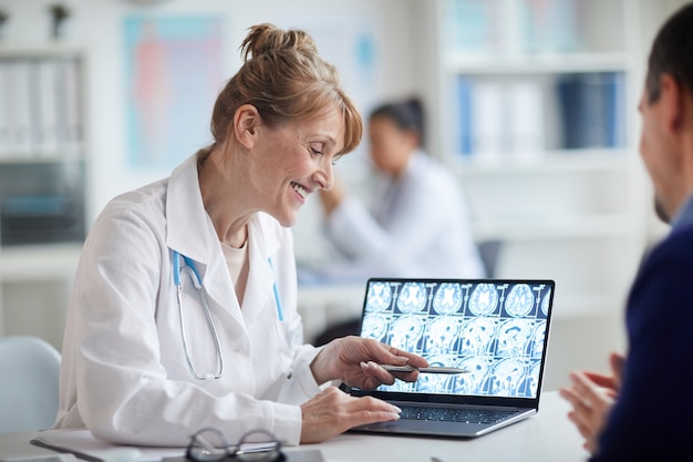 Mature female doctor talking to patient