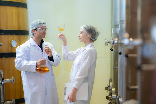 Mature female and male researchers and developers working in winery