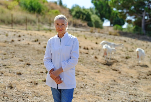 Mature female veterinarian on a farm