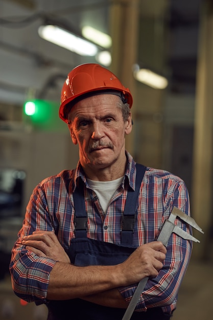 Mature foreman working in the factory