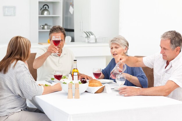 Mature friends taking lunch together