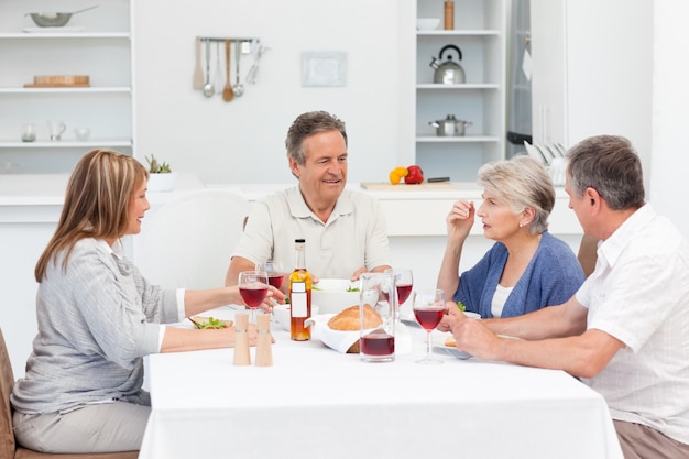 Mature friends taking lunch together