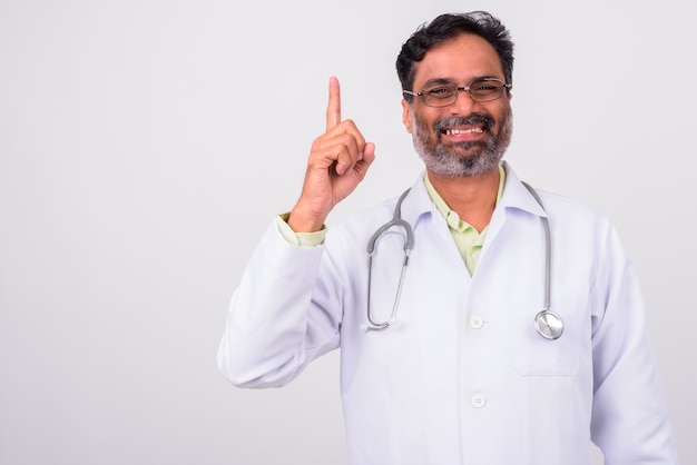 mature handsome bearded Indian man doctor on white