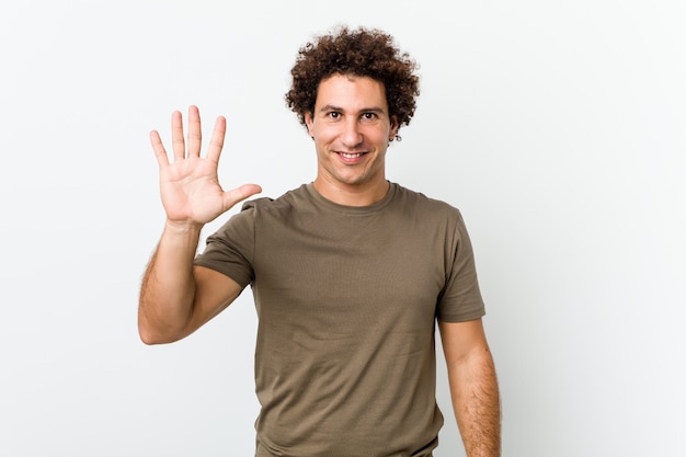 Mature handsome man isolated smiling cheerful showing number five with fingers.