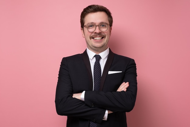 Mature happy businessman in suit looking at camera with a bright smile