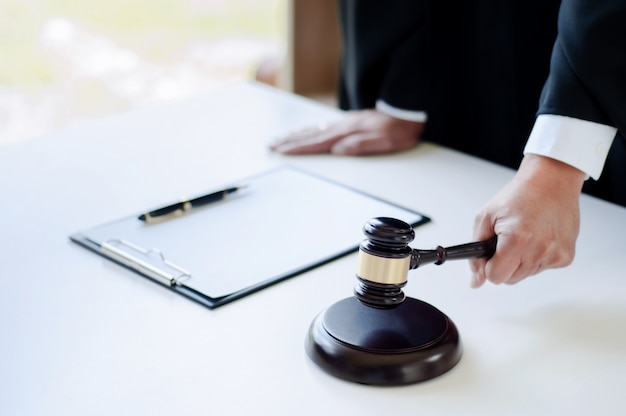 mature lawyer working at courtroom with justice hammer on hand