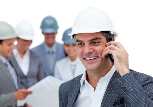 Mature male architect on phone standing