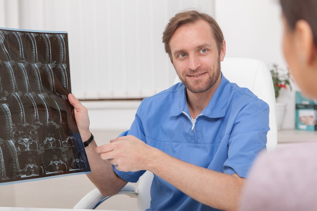 Mature male doctor examining MRI scan of a patient